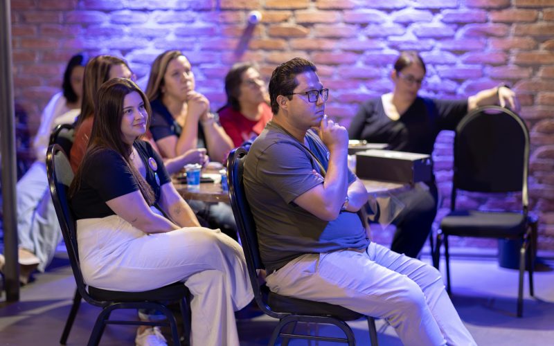 Attentive audience members listening during an indoor seminar or workshop.