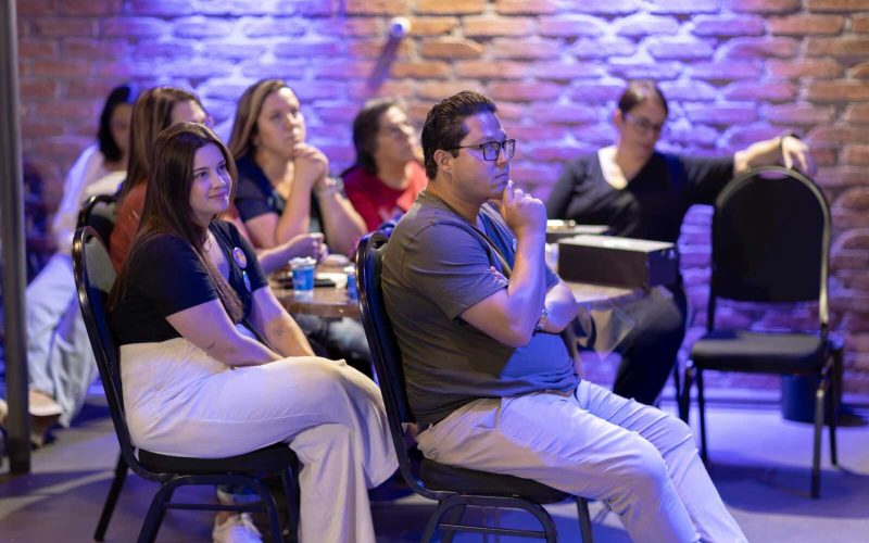 Attentive audience members listening during an indoor seminar or workshop.
