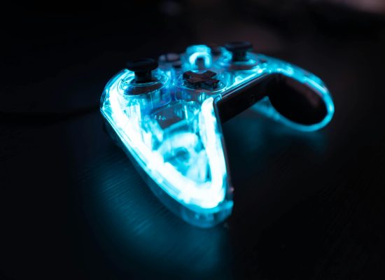 Illuminated gaming controller with blue lights on a dark background, perfect for gaming themes.